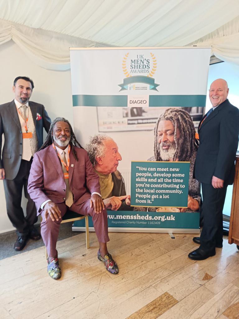 A photo of Shane with a Shane poster.
